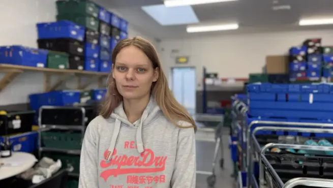 Woman in food bank warehouse