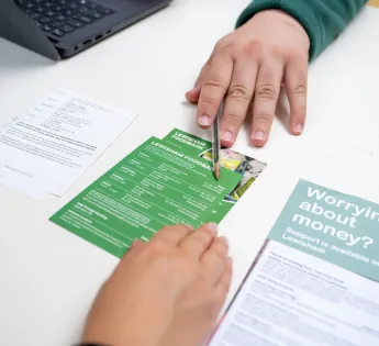 A volunteer and a clients hand at the Lewisham foodbank