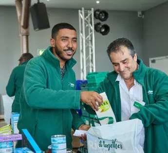 Two men packing bags of food at Bradford food bank