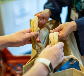 Bag of food being passed between two people