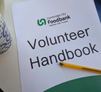 Booklet reading 'Volunteer handbook'