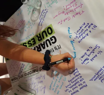 Child writing on a campaigning tablecloth