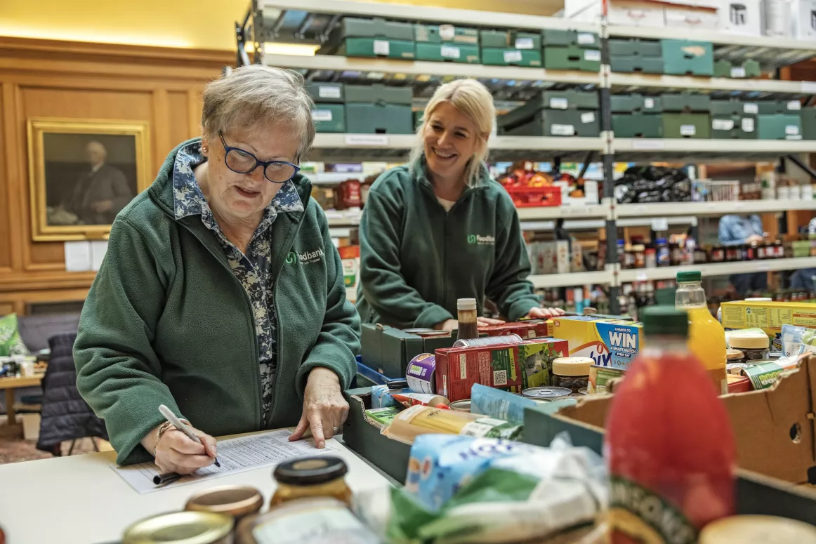 Two women working at the Peeblesshire food bank warehouse