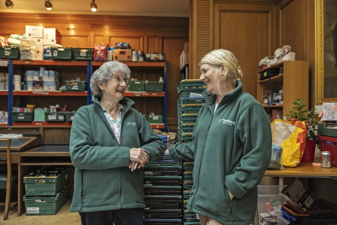 Two woman smiling at Peeblesshire food bank