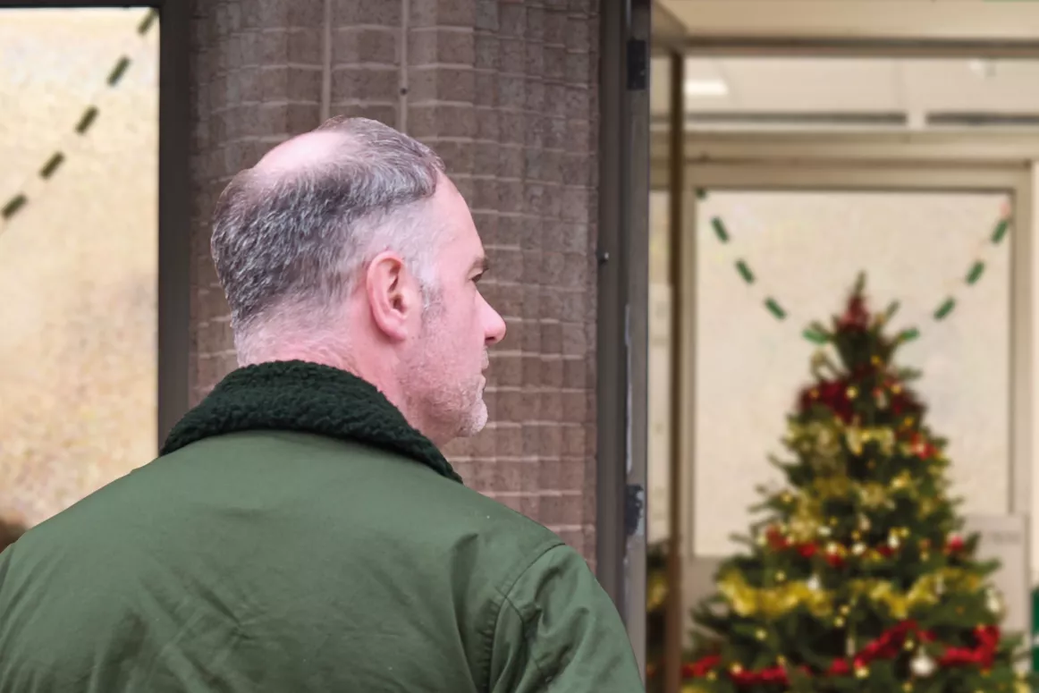 A person walks towards the entrance of a food bank