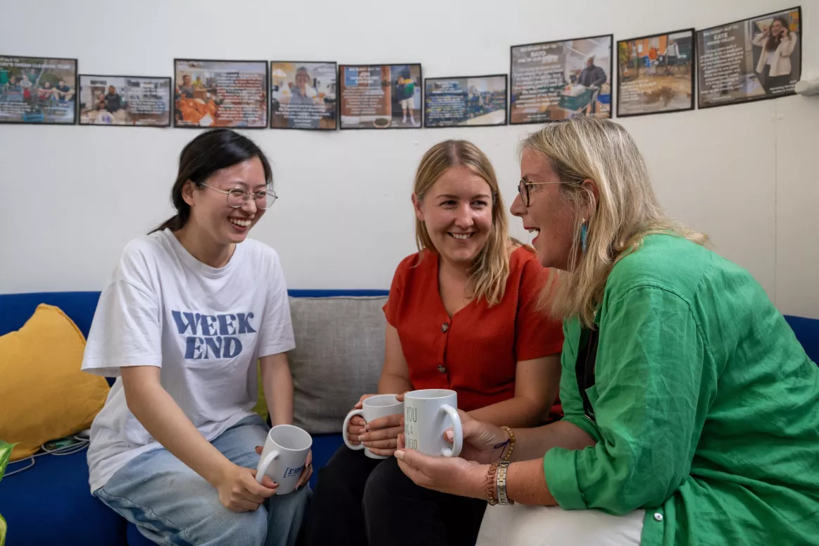 Three people have a conversation