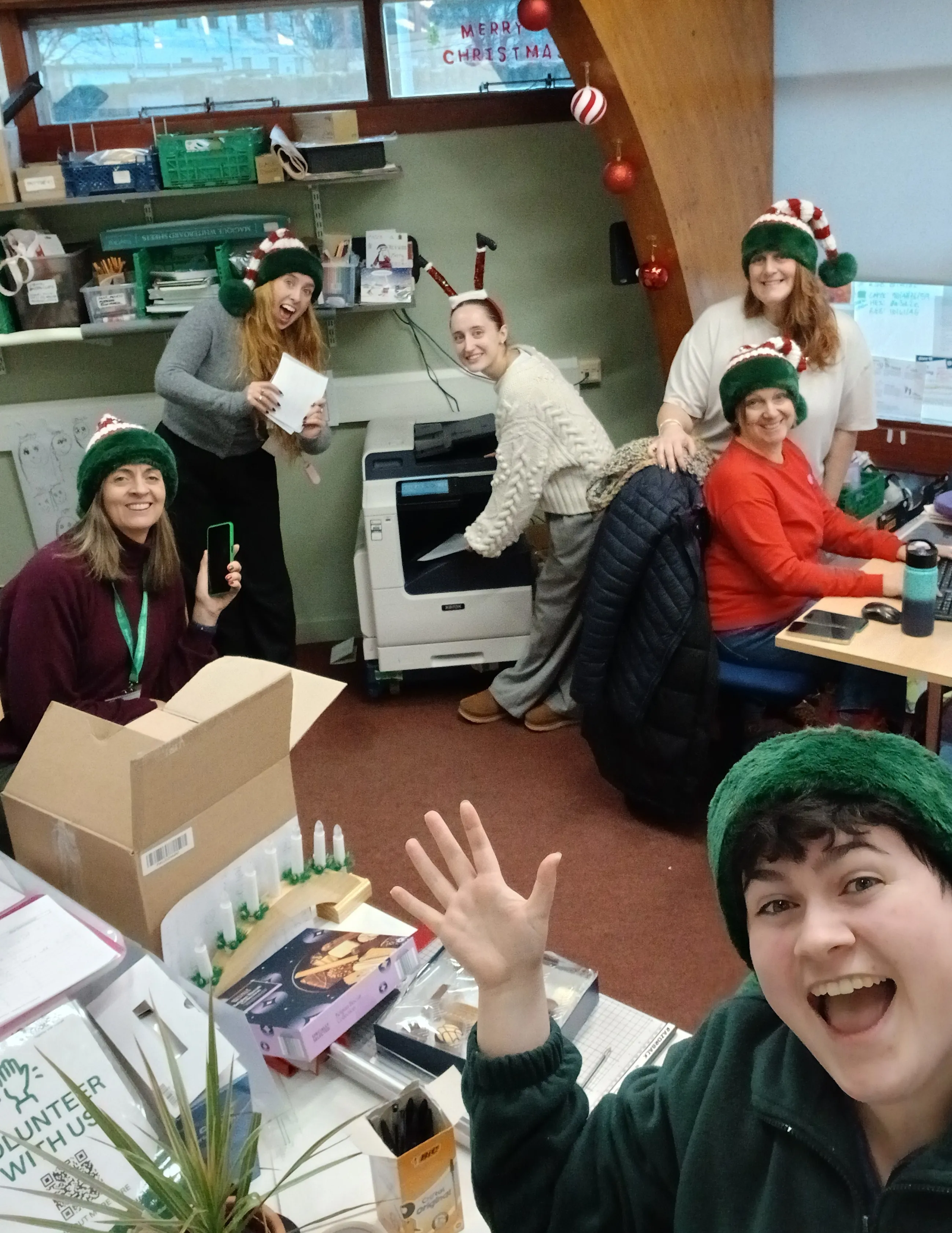 Picture of foodbank team members posing for a photo in the office