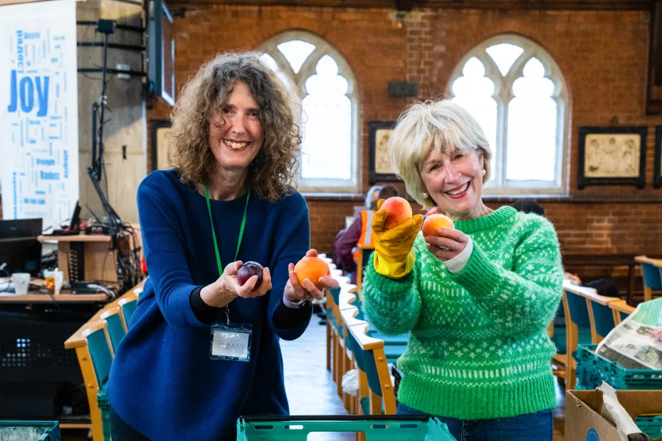 Two women with fruit donations