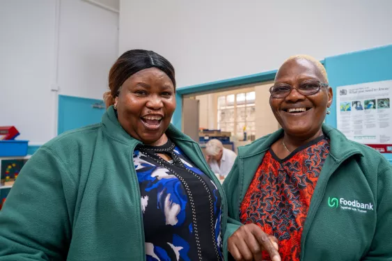 Two women smiling at Lewisham food bank