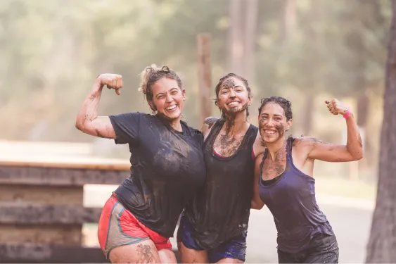 a group of woman doing a mud run challenge