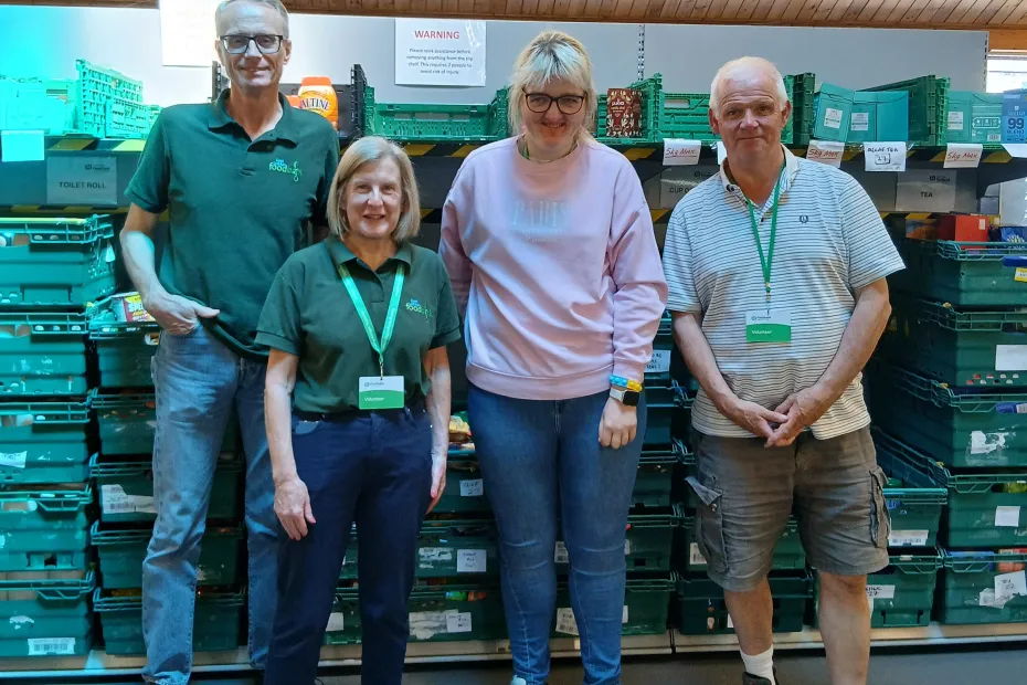 a photo of a group of four people standing in our foodbank warehouse