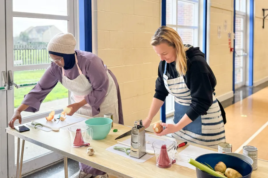 two women chopping vegetables