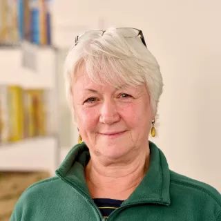 A food bank volunteer smiles into the camera