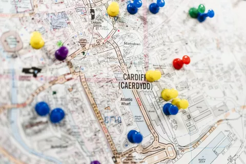 Pins on a paper map of Cardiff