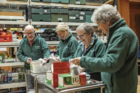 A team working on packing and labelling food containers at the Peeblesshire food bank