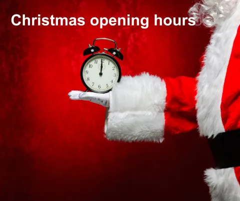 Santa holding up a clock with a title across the top saying Christmas opening hours