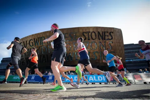 Runners going past Millennium Centre