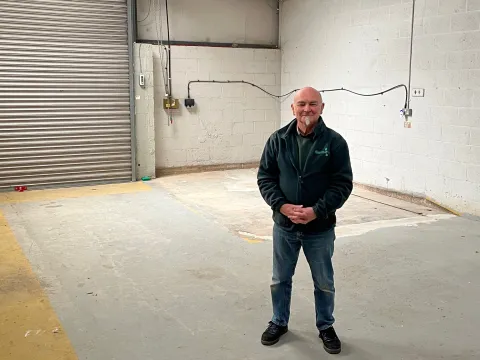 Foodbank manager Grahame Lucas stands in an empty storage unit